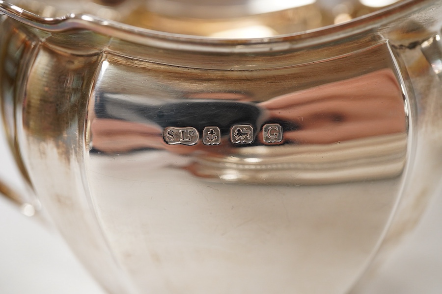 A George V silver two handled butter dish, by George Howson, Sheffield, 1928, 16.7cm over handles, together with a George V silver cream jug, by William Suckling Ltd, Birmingham, 1931, 10.7oz.